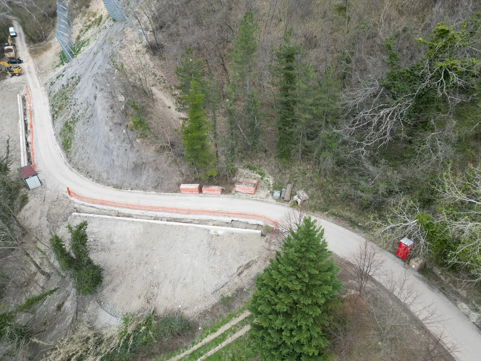 Strada di montagna con tornante ripristinato, protetta dalla scarpata consolidata